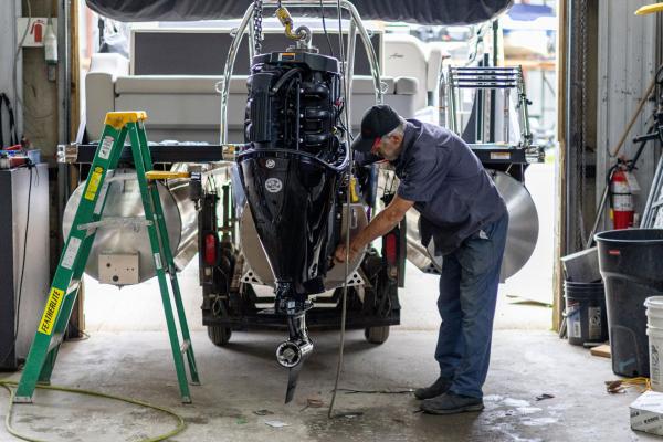 Marine Mechanic working on a boat at Huntsville Marine